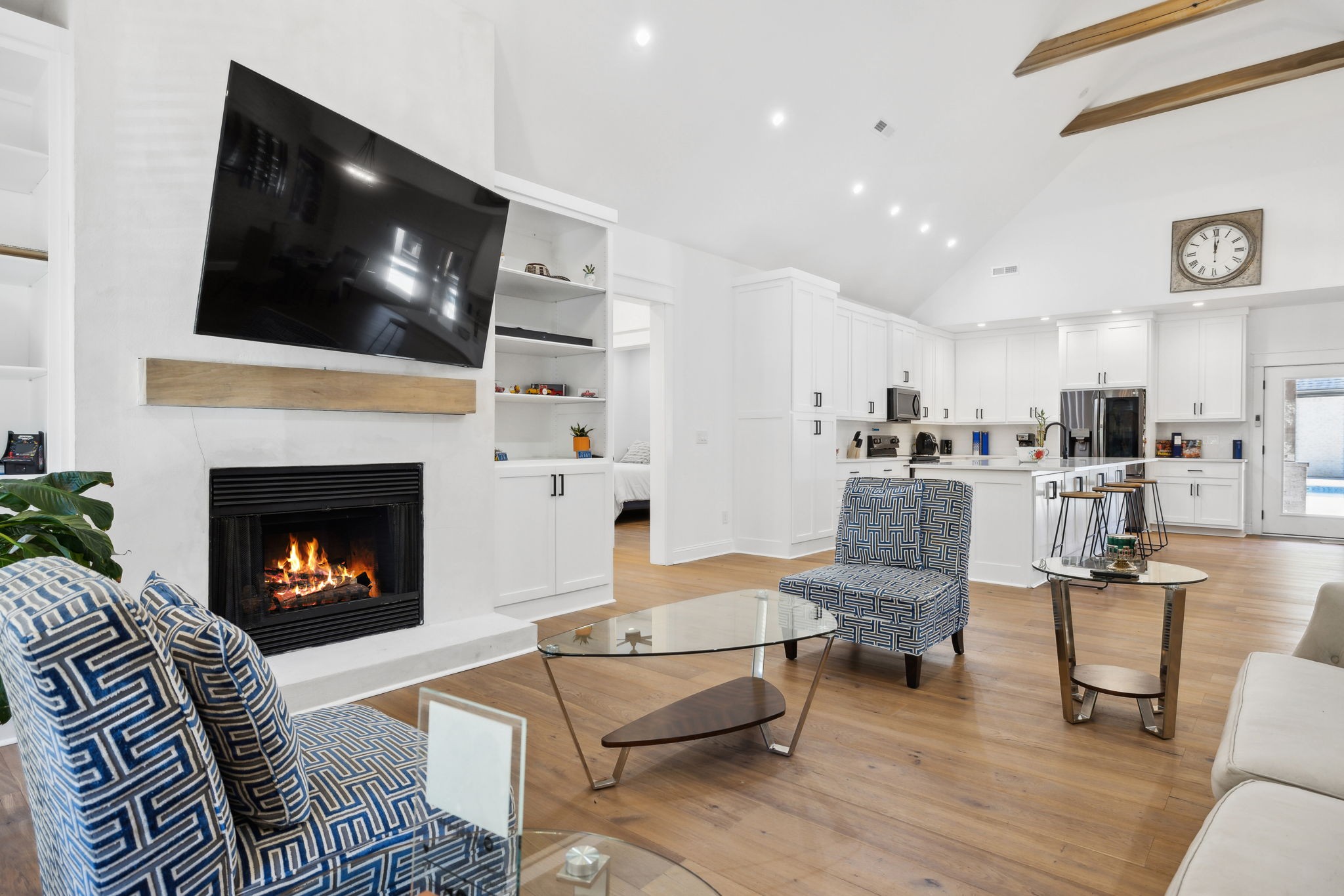 a living room with furniture a flat screen tv and a fireplace