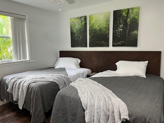 a bedroom with two large bed and a large window