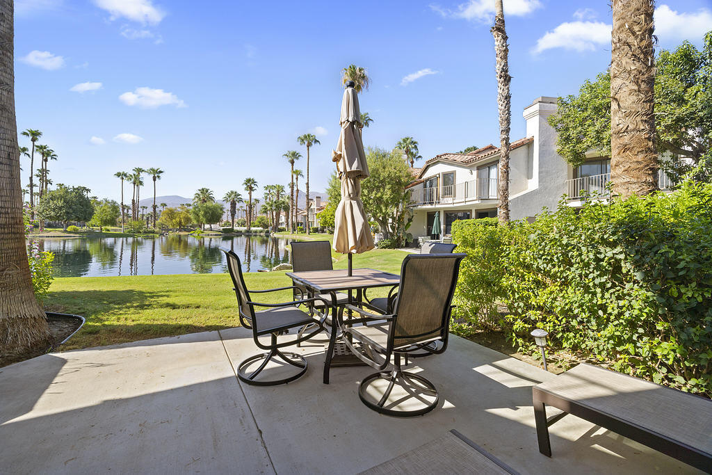 a view of a patio with table and chairs and potted plants