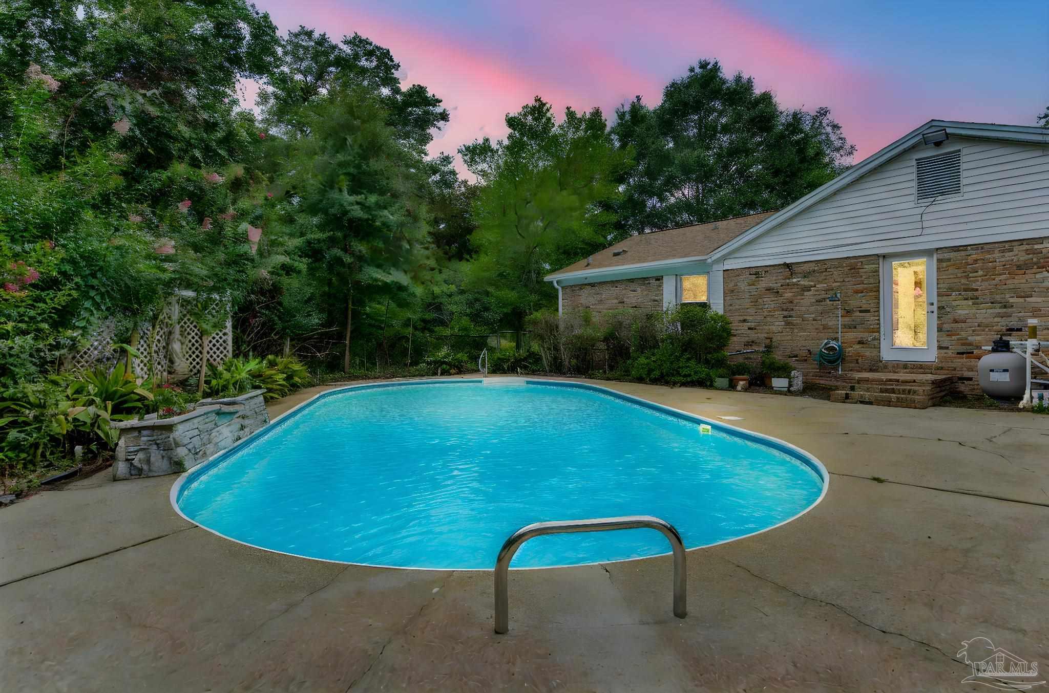 a view of a swimming pool with a yard