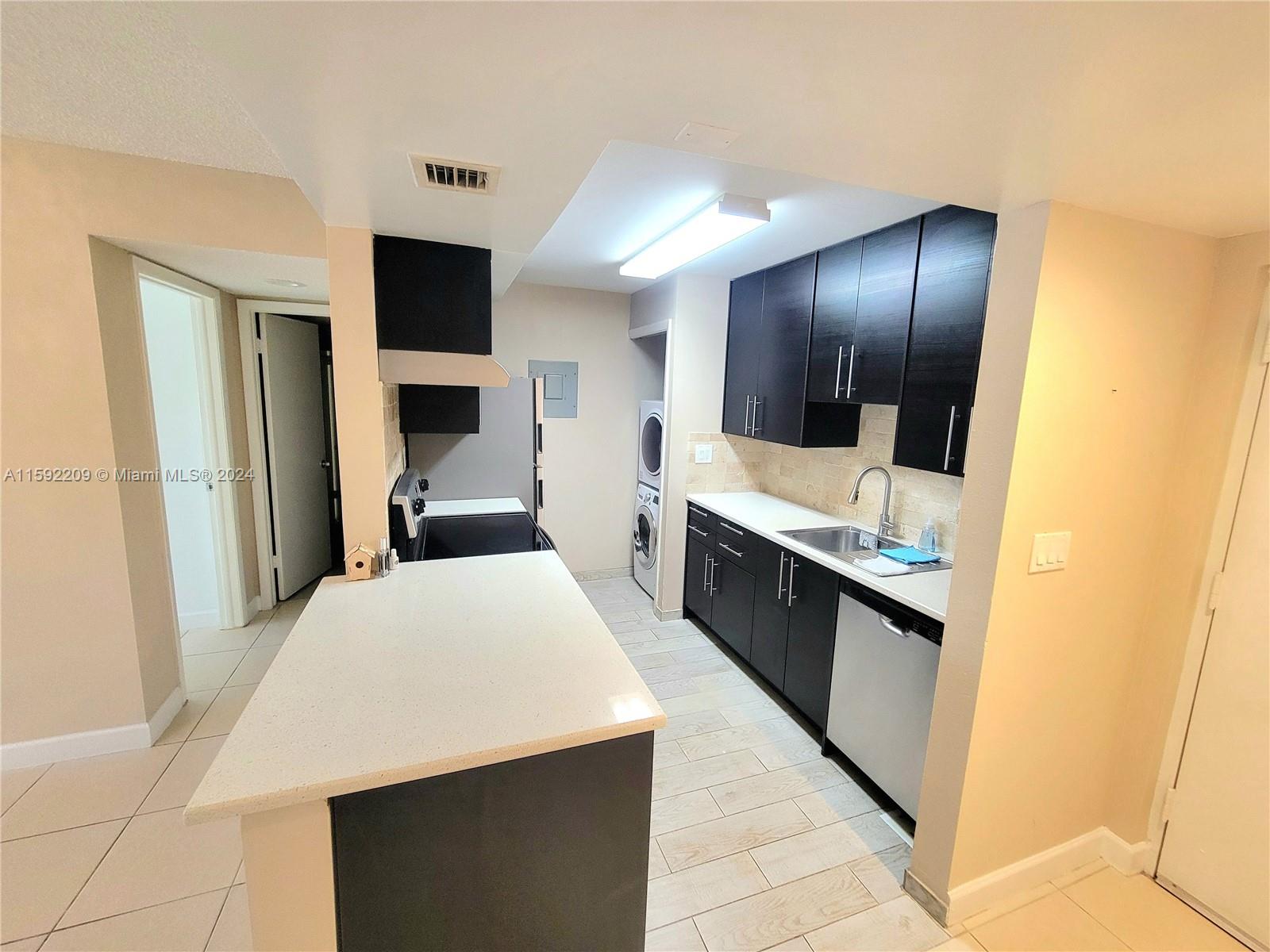 a large white kitchen with a large window