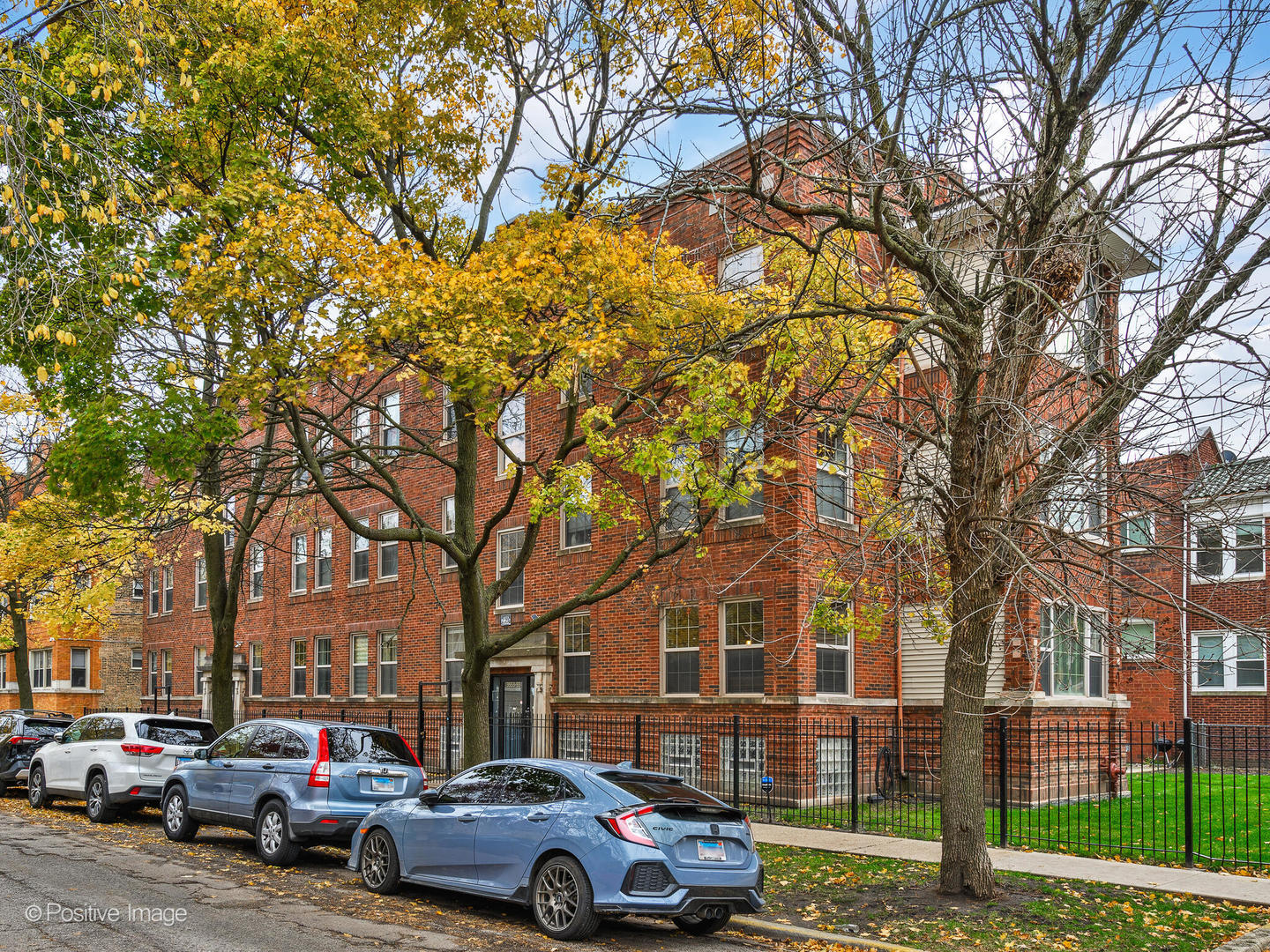 a front view of a building with trees