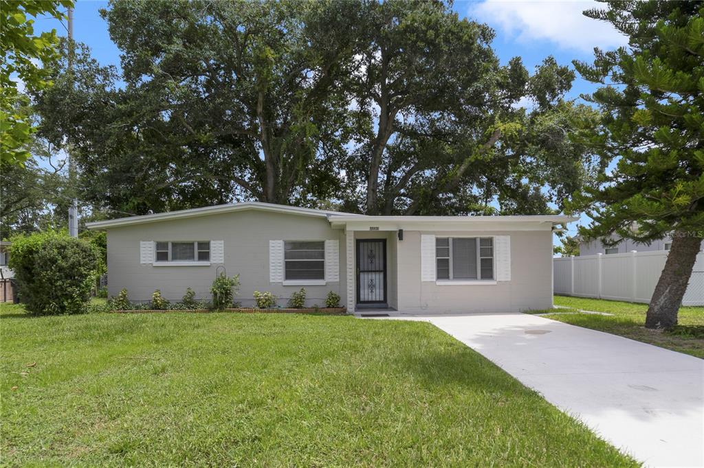 a front view of house with yard and trees