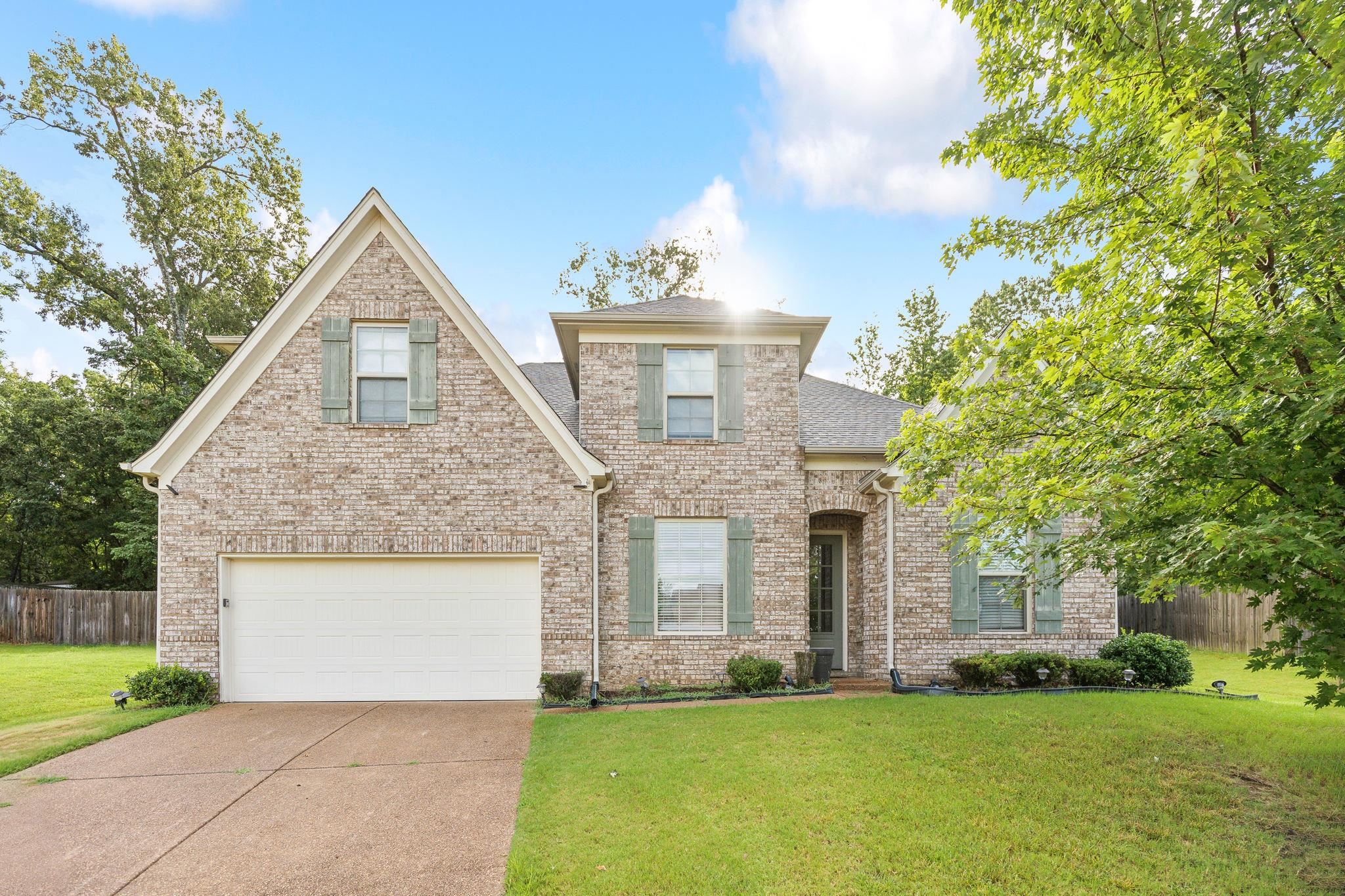 View of front of home featuring a garage and a front lawn