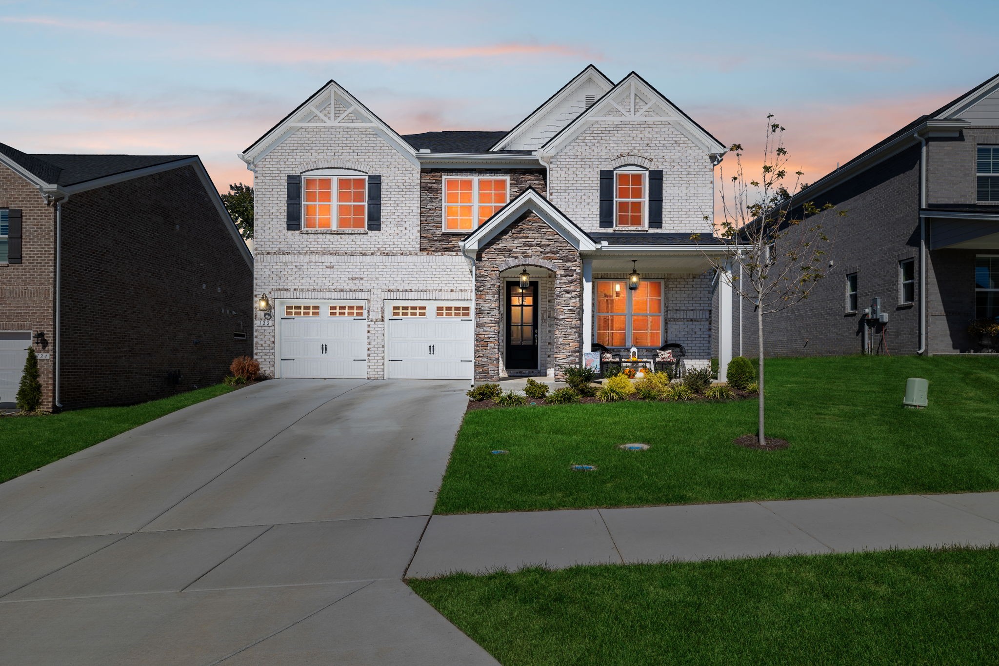 a front view of a house with a yard and garage