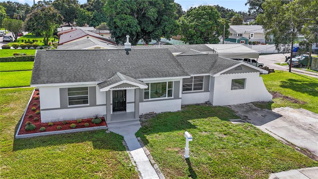 a aerial view of a house next to a yard