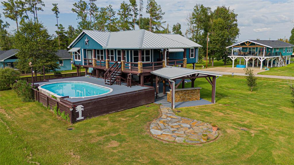 a swimming pool with outdoor seating and yard