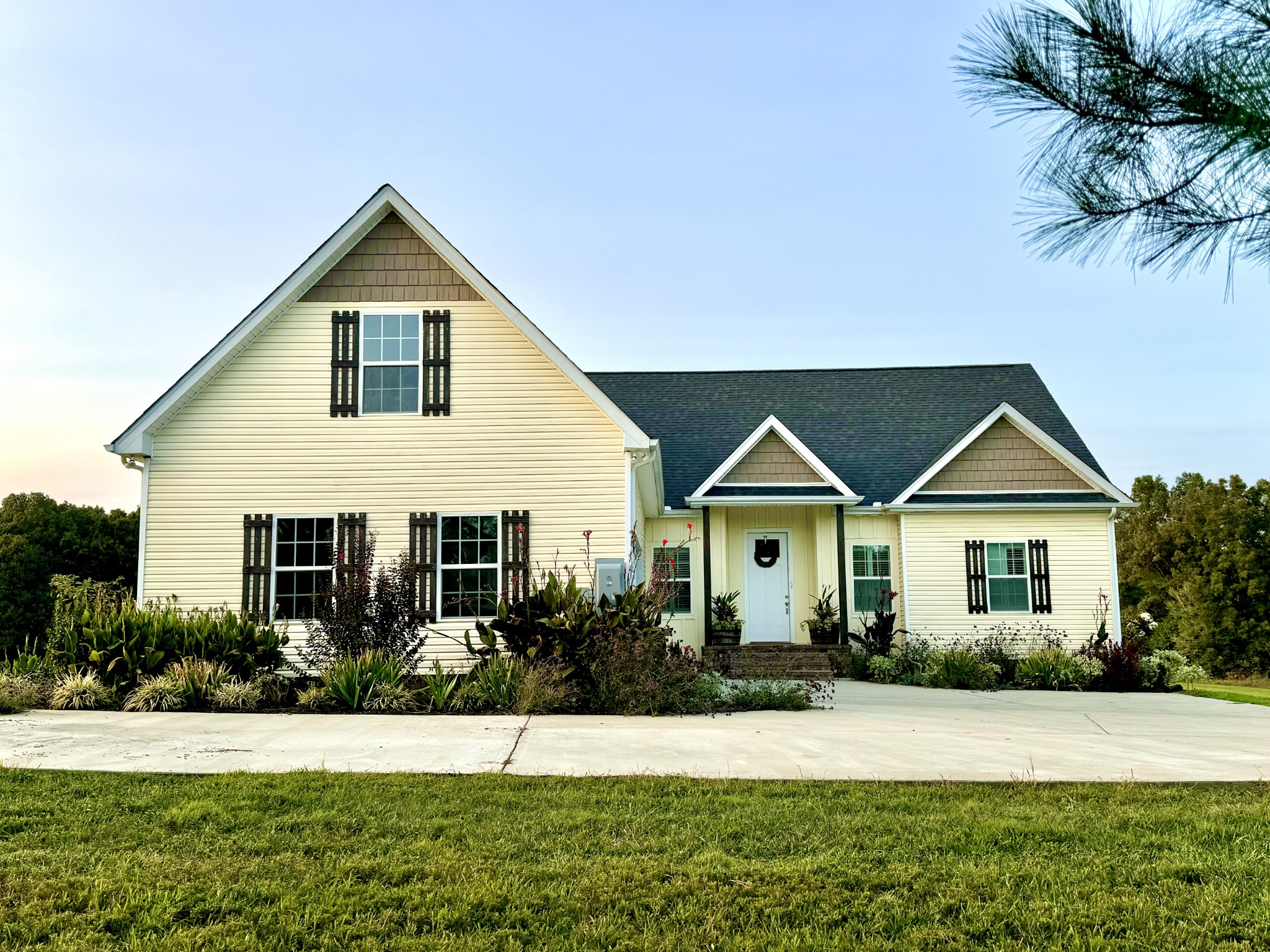 a front view of a house with a garden