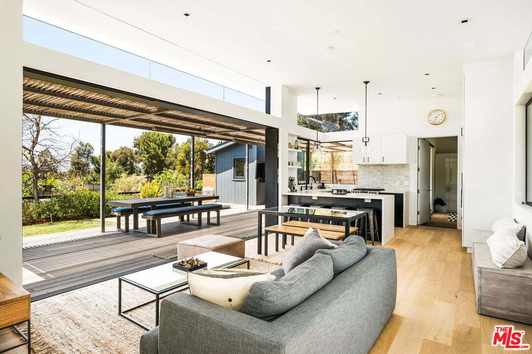 a living room with fireplace furniture and a large window