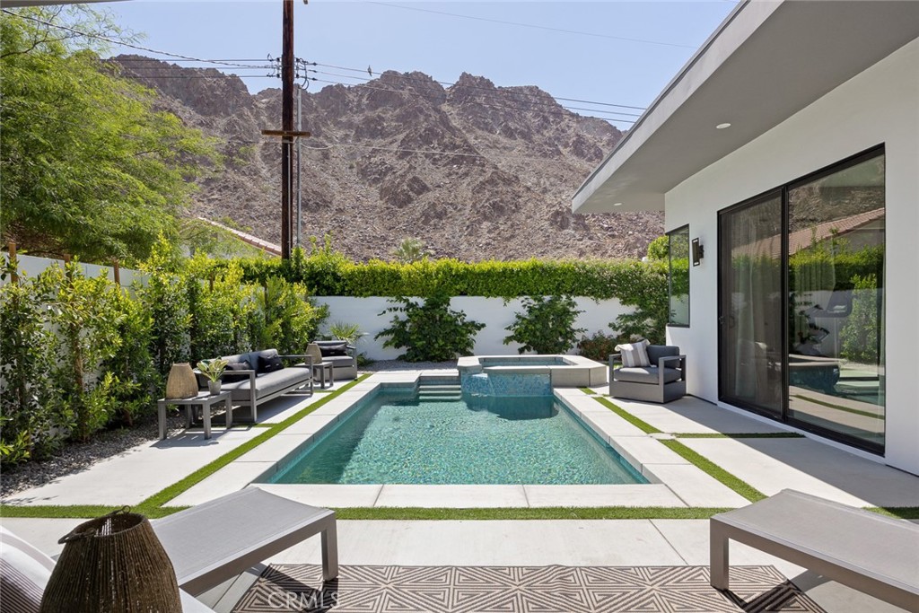 a view of swimming pool with seating area