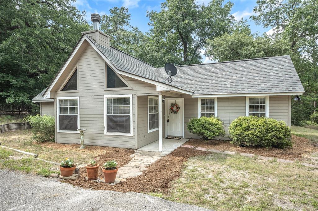 a view of a house with a yard and plants