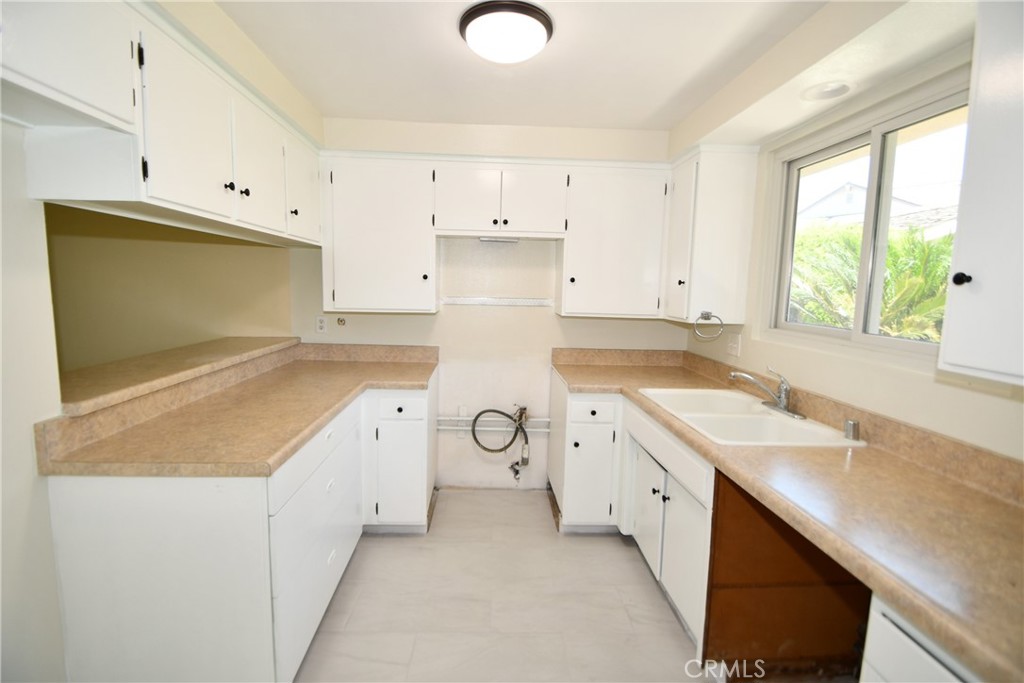 a utility room with cabinets washer and dryer