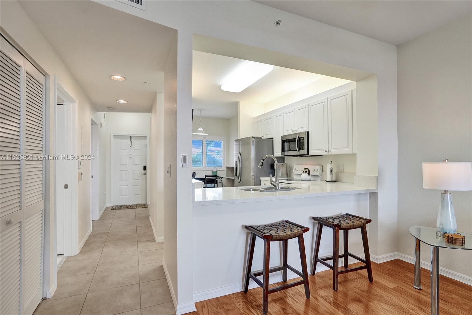 a view of a dining area kitchen with furniture and wooden floor