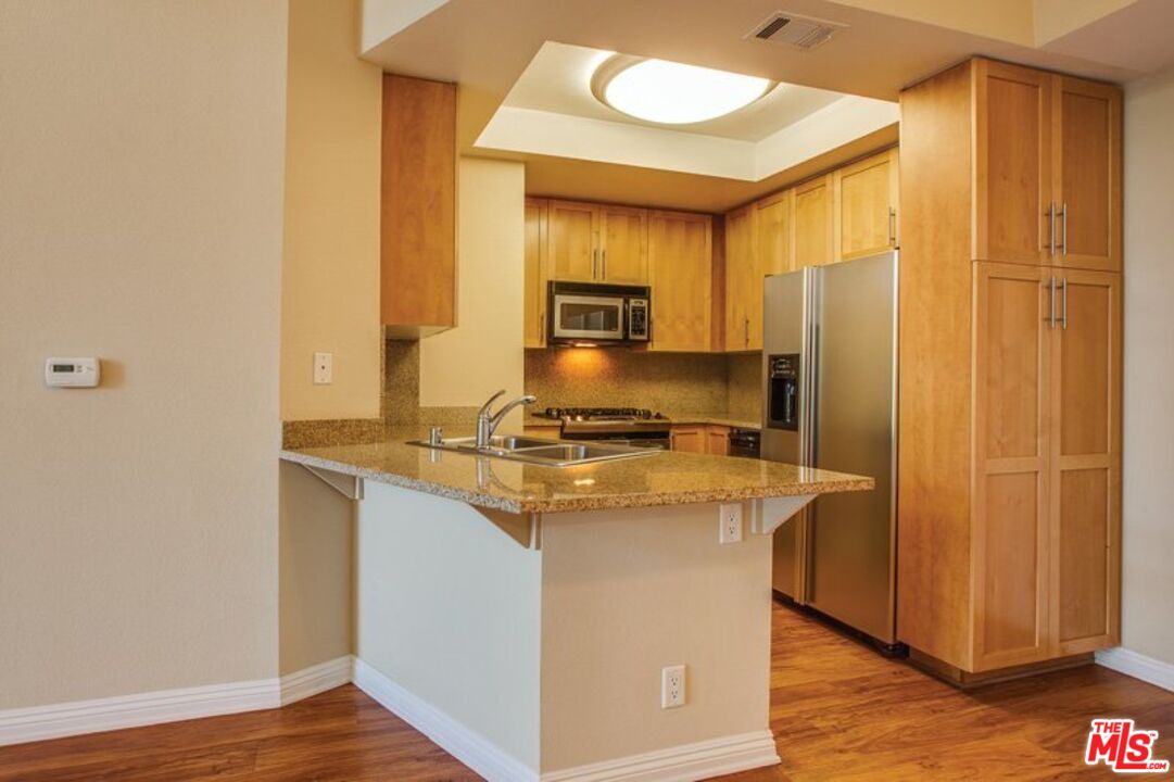 a kitchen with a stove a sink and a refrigerator