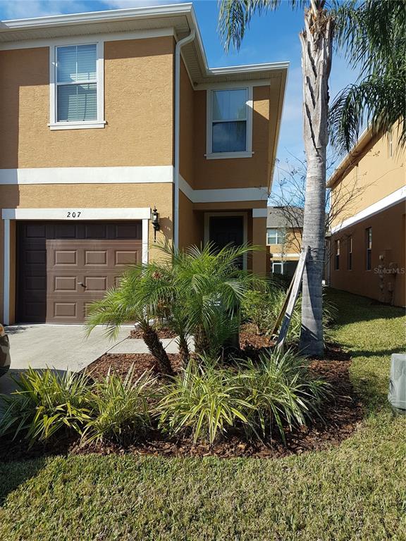 a view of a house with a yard and plants