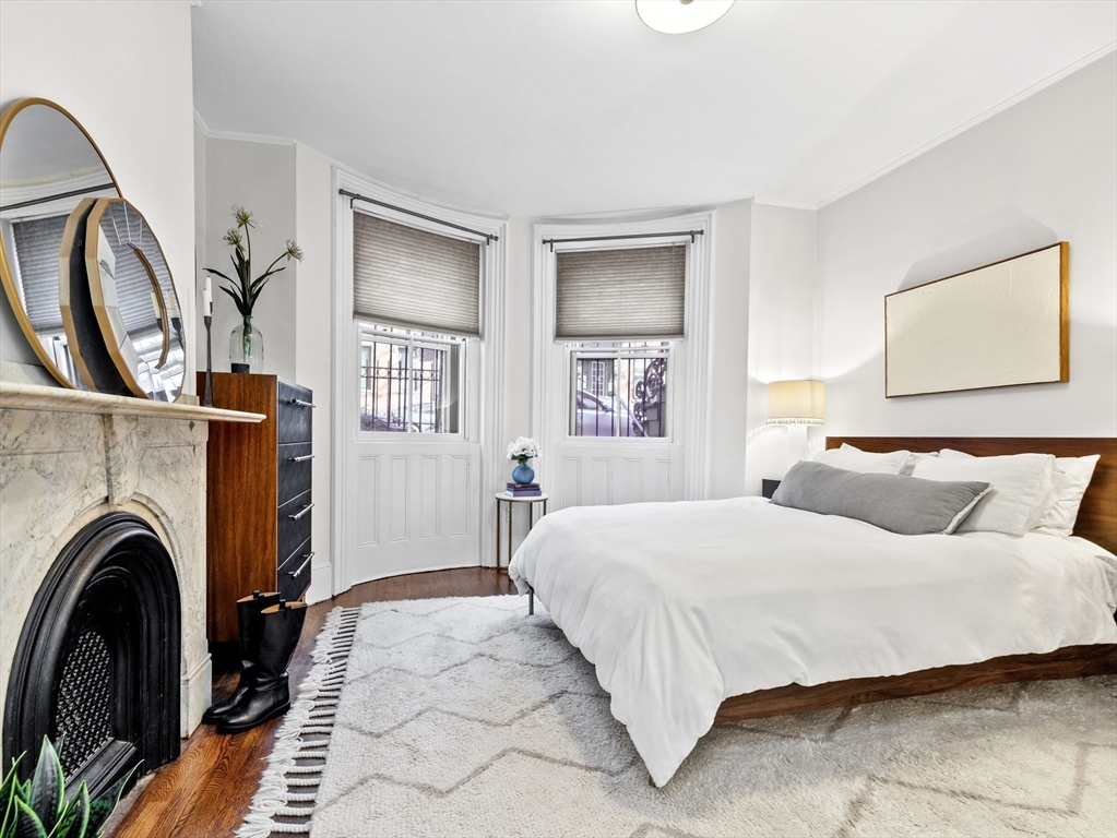 a bedroom with a large bed and a fireplace