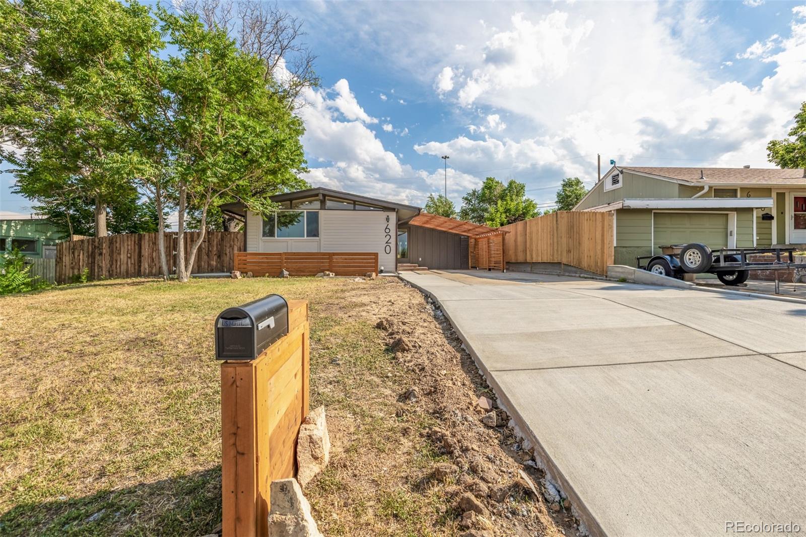 a view of a yard with wooden fence