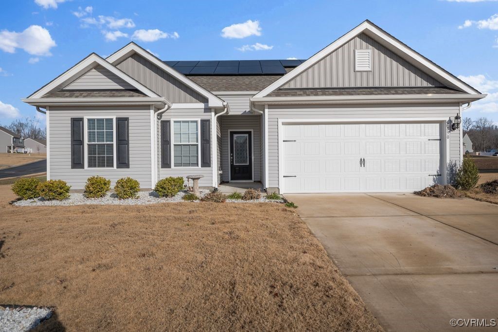 View of front of property featuring a garage and s