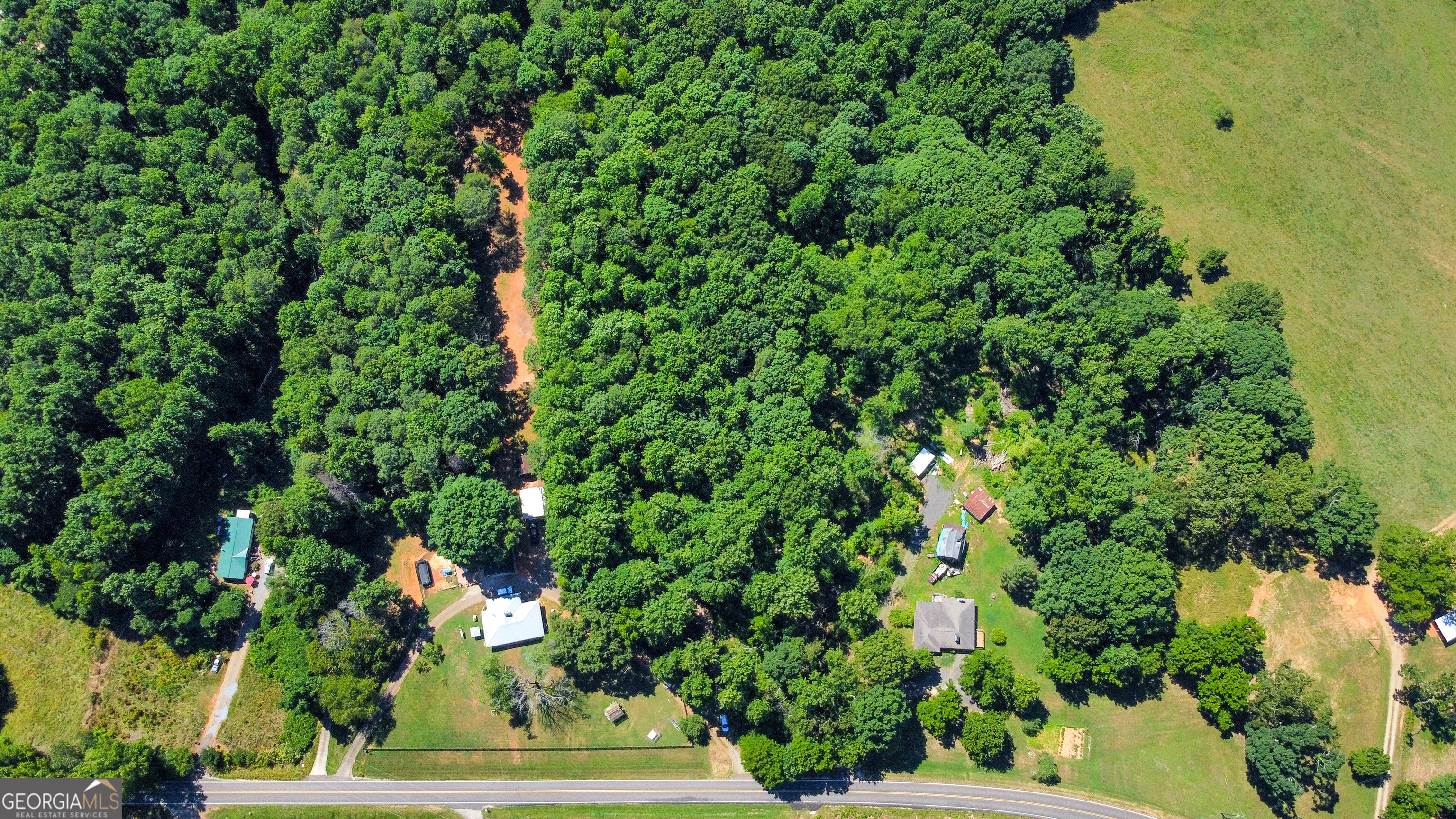 an aerial view of a house with a yard