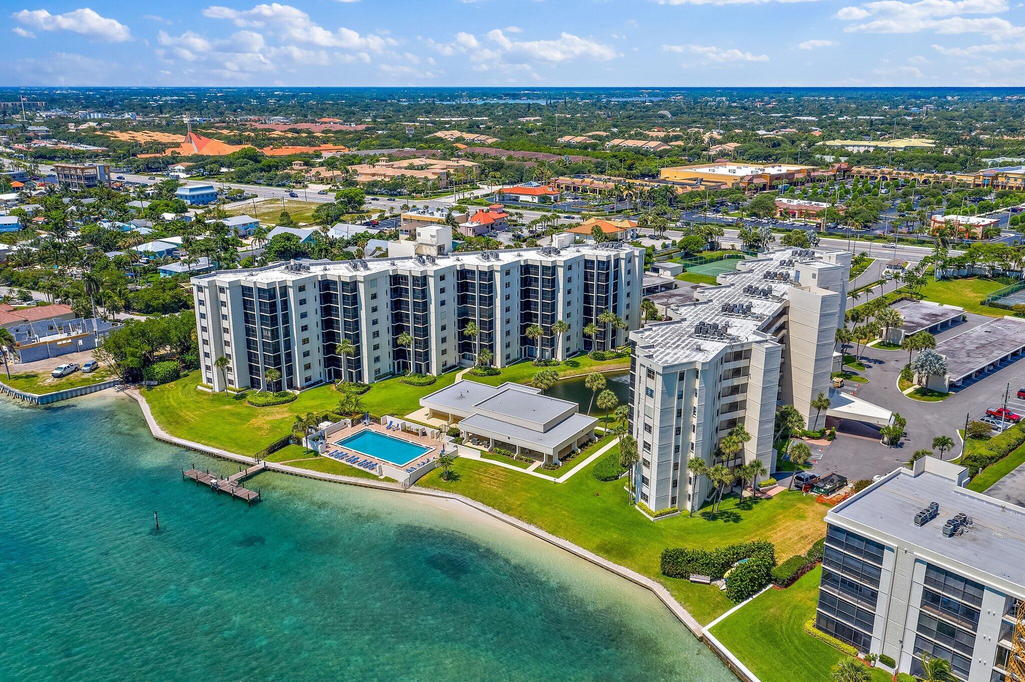 an aerial view of residential houses with outdoor space and swimming pool