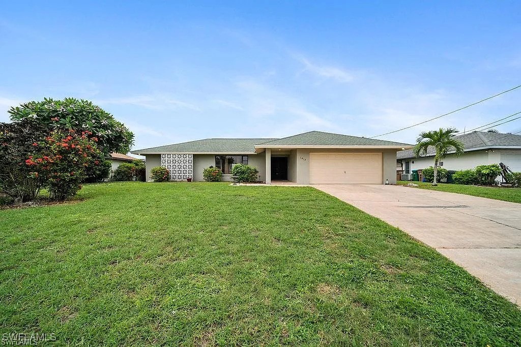 a front view of house with yard and green space