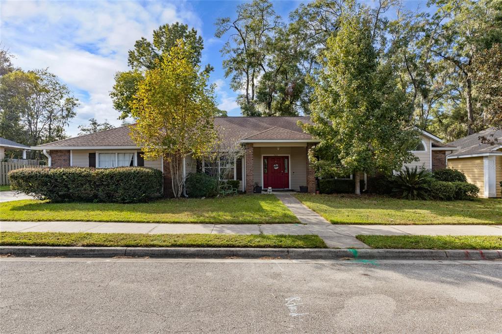 a view of a house with a patio and a yard