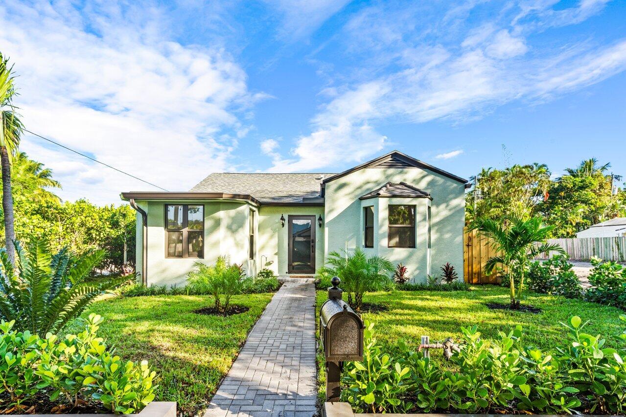 a front view of a house with garden