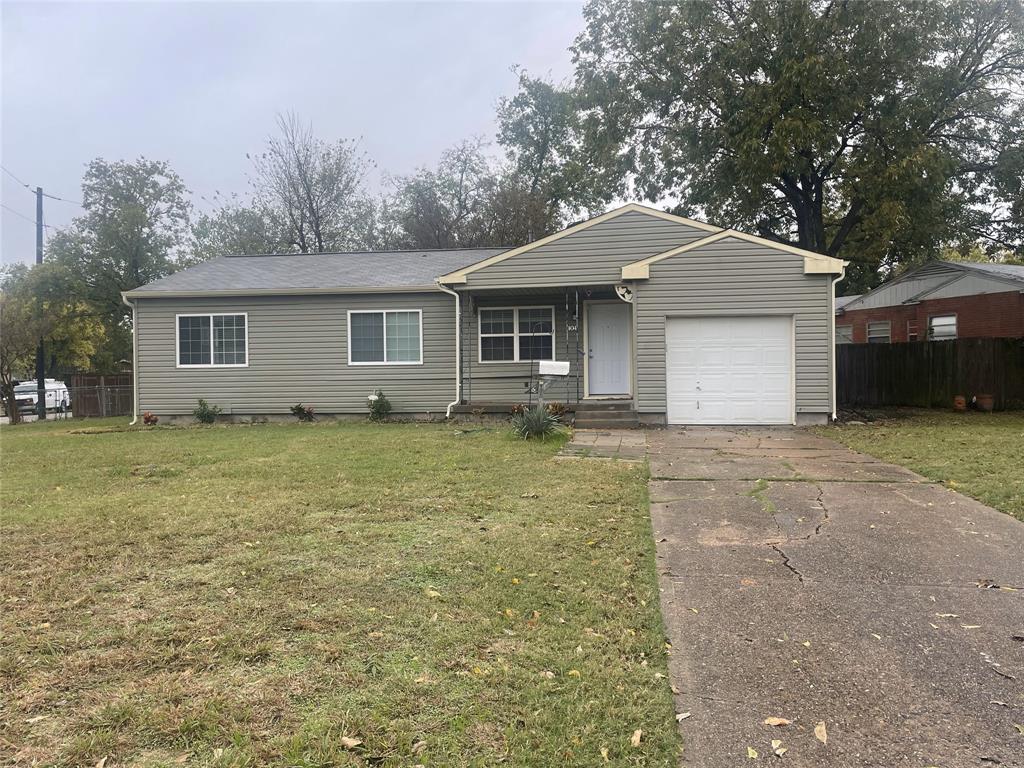 Ranch-style house with a garage and a front yard