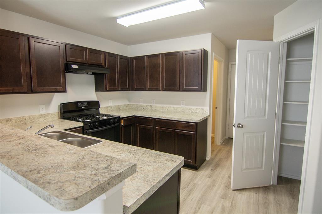 a kitchen with a stove and a refrigerator