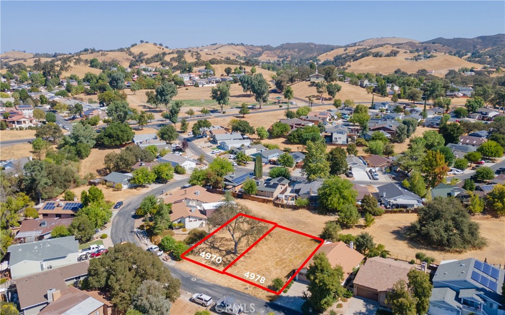 an aerial view of a houses and a mountain view