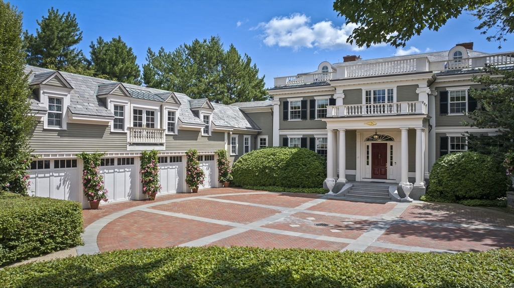 a front view of a house with yard and green space