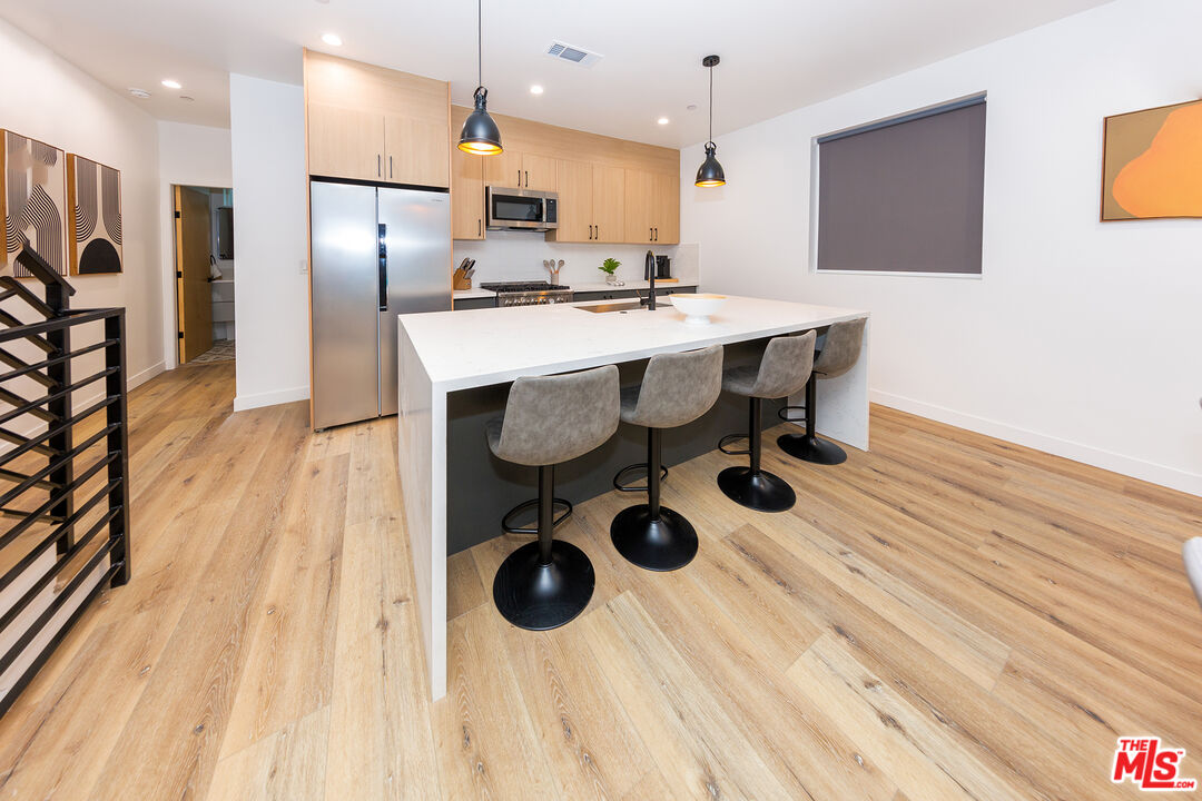 a kitchen with a sink cabinets and stainless steel appliances