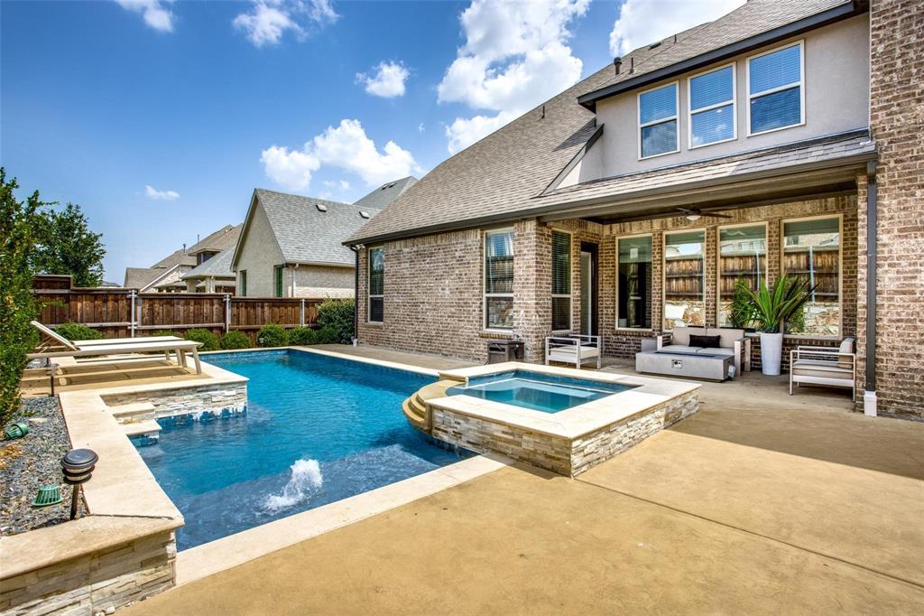 a view of a house with swimming pool and sitting area