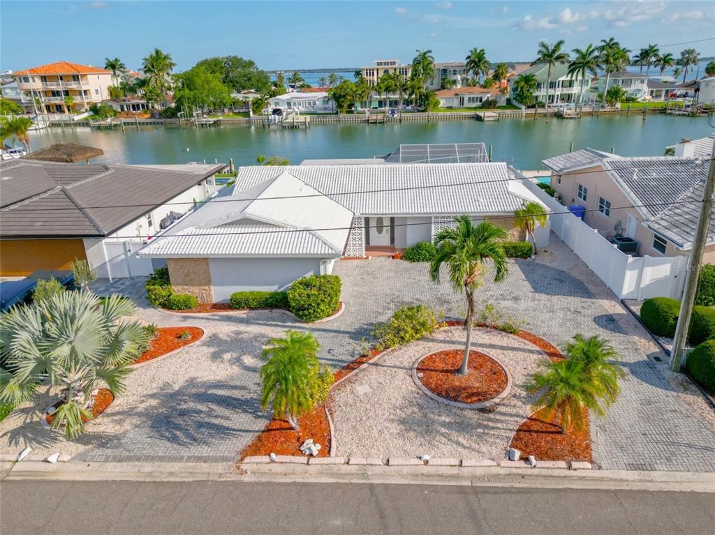 an aerial view of a house with outdoor space lake view and a chair