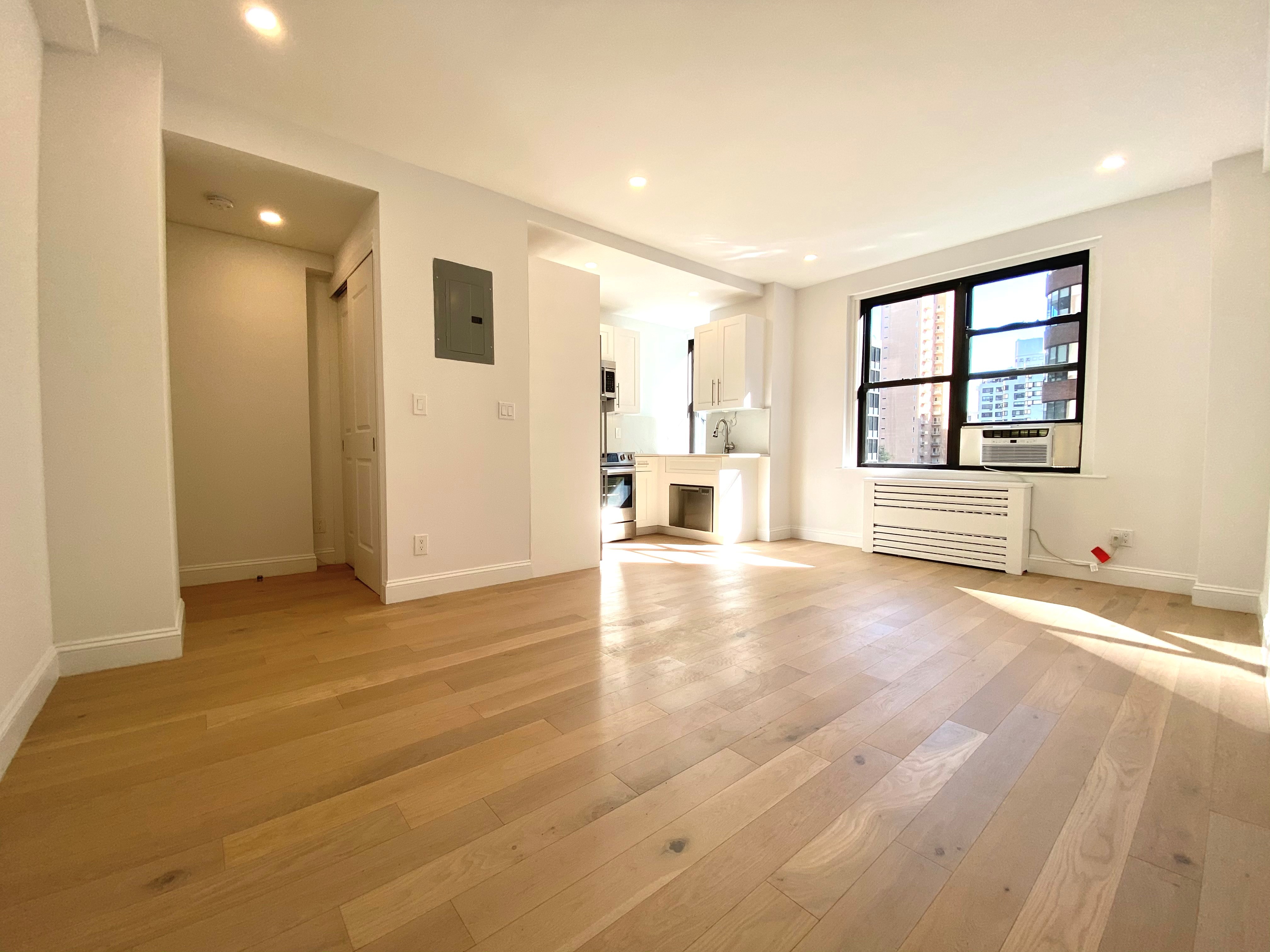 a view of a livingroom with an empty space and a window