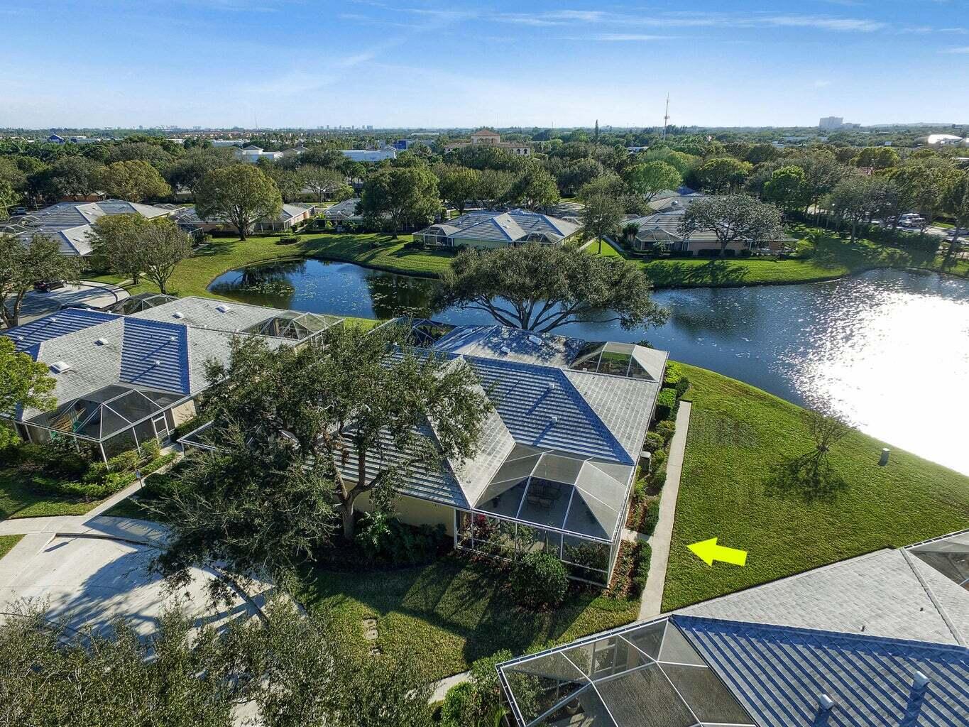 an aerial view of a house with a garden and lake view