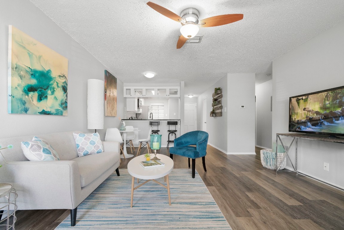 Unwind in the inviting living room, where abundant natural light dances off stylish vinyl plank flooring and the neutral toned walls