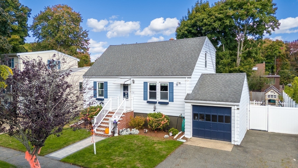 a aerial view of a house with a yard and potted plants