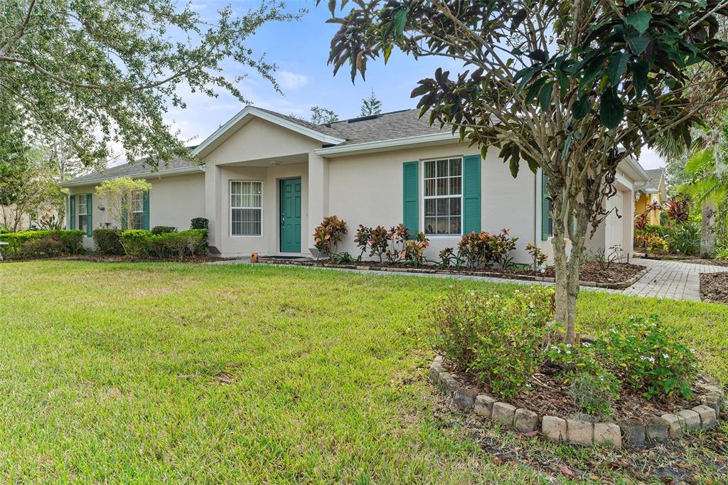 a front view of house with yard and green space