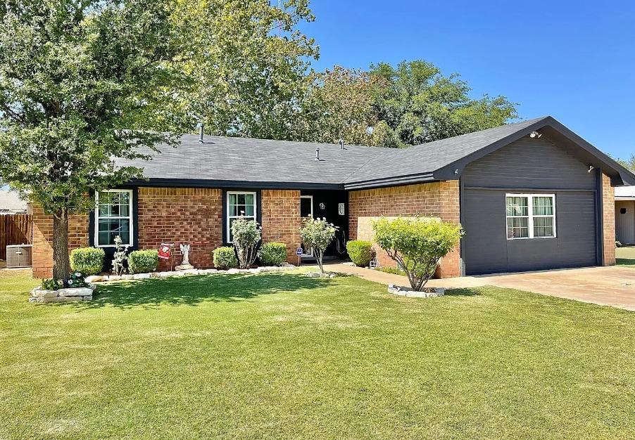 a view of a house with a yard and sitting area