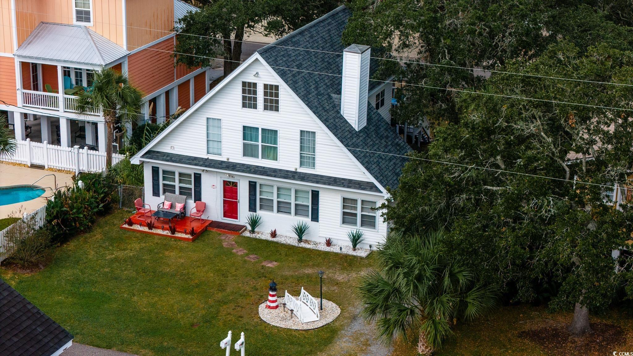 View of front of home featuring a fenced in pool a