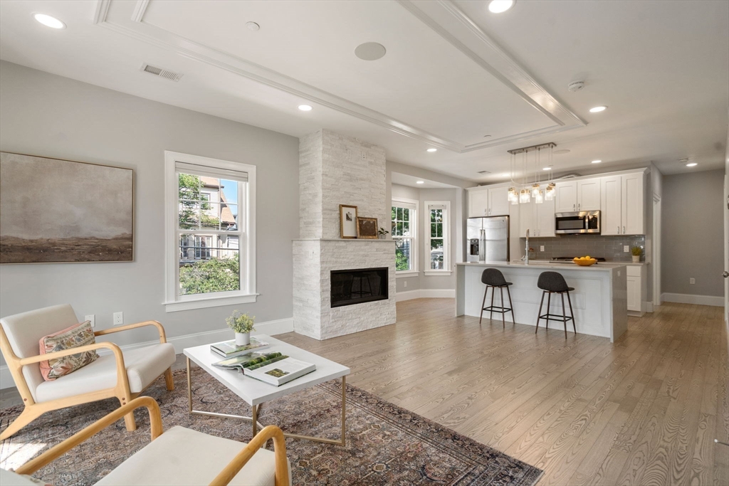 a living room with furniture a fireplace and a table