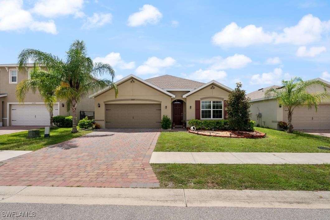 a front view of a house with a garden and yard