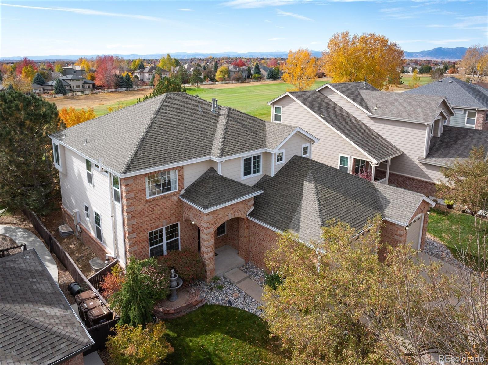 an aerial view of a house with yard swimming pool and outdoor seating