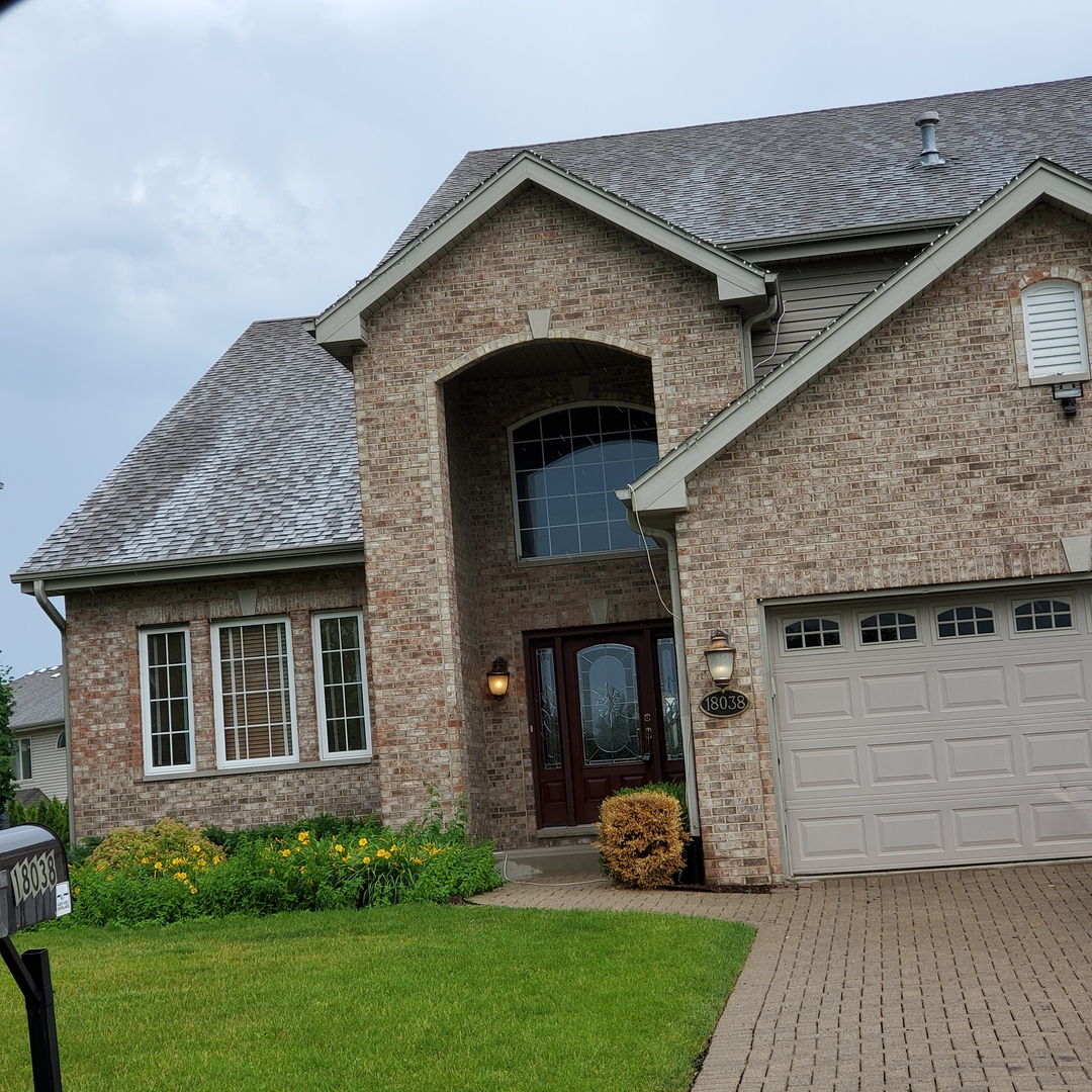 a front view of a house with a yard and a garage