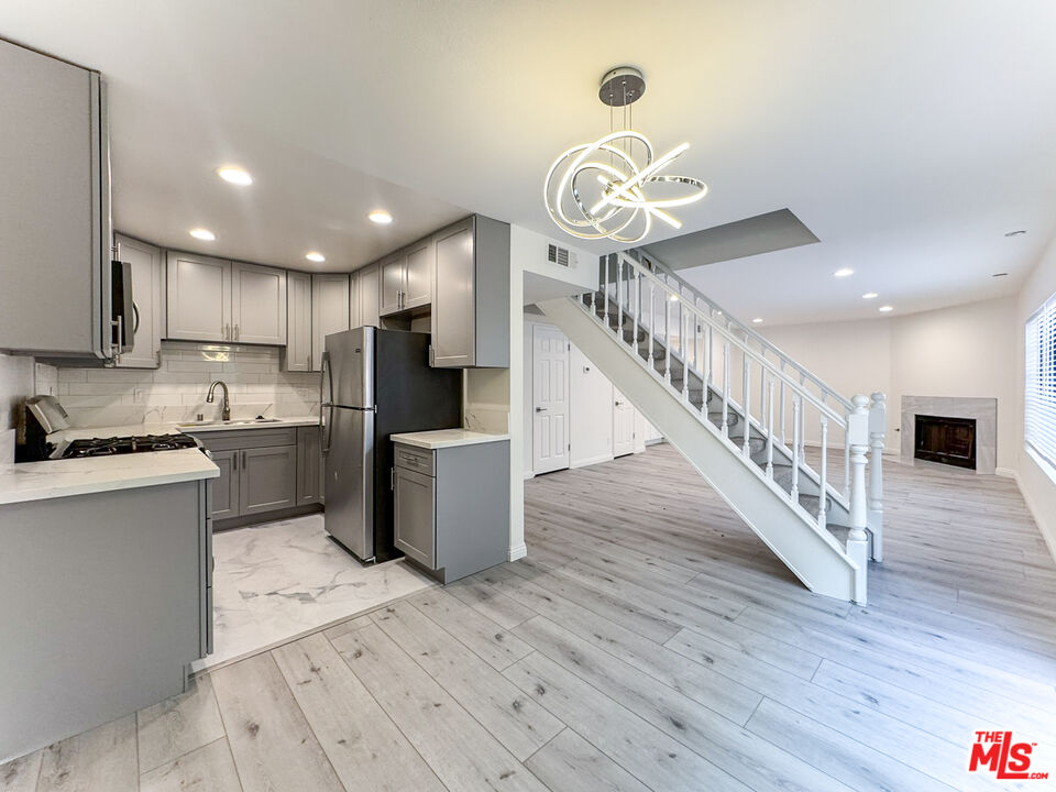 a kitchen with a refrigerator and a microwave