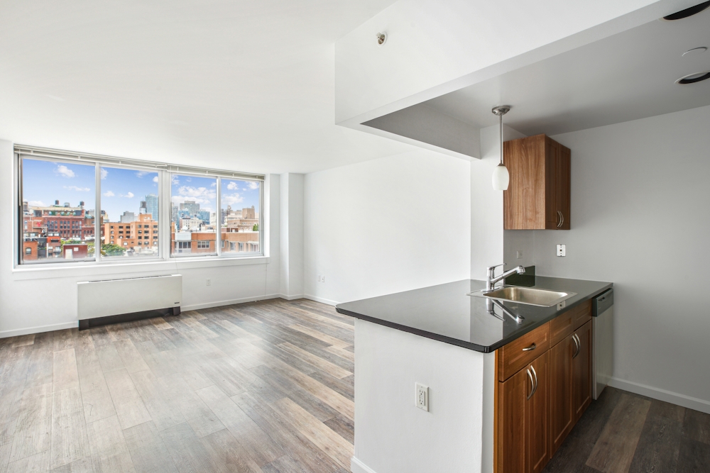 a kitchen that has a sink and a stove in it