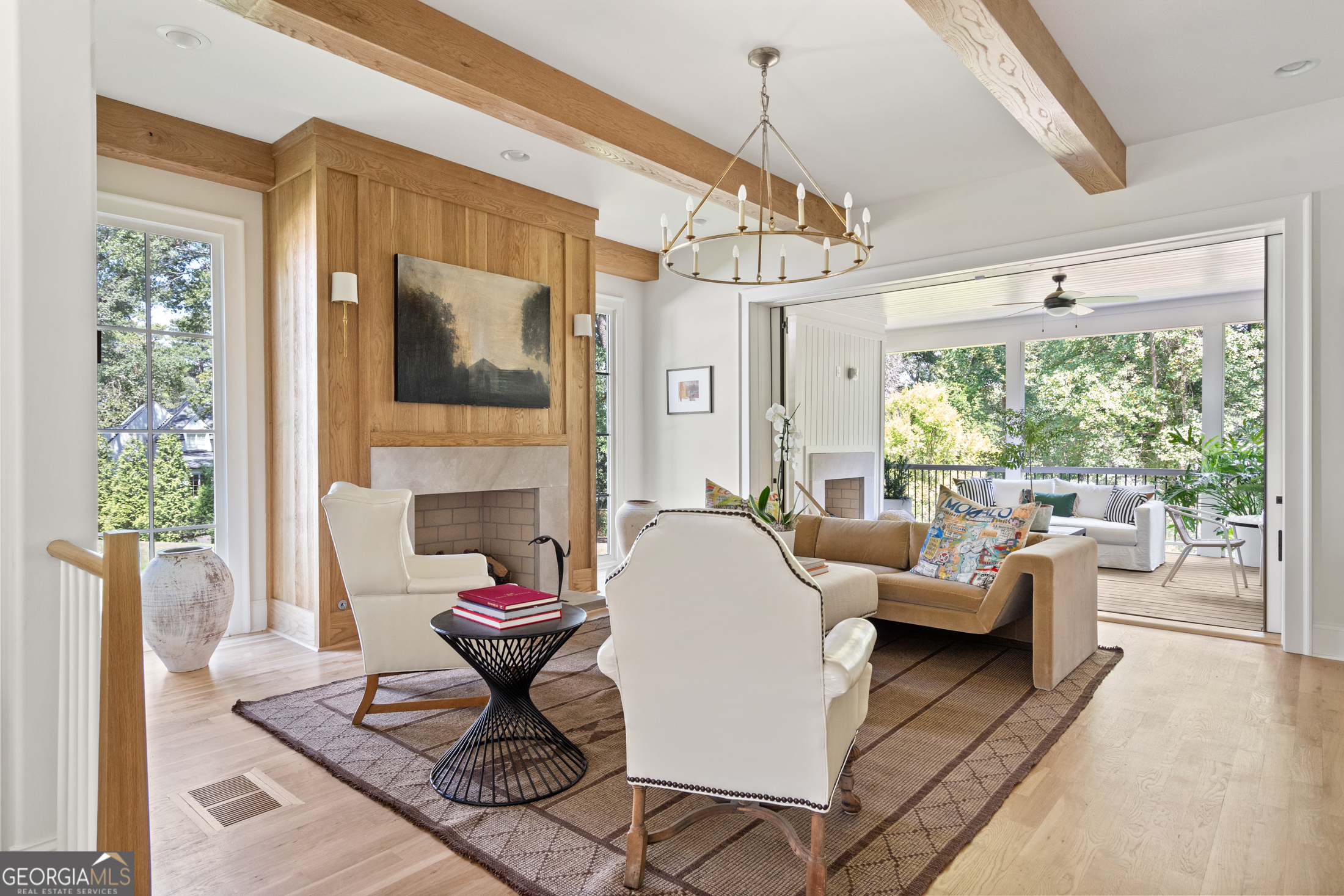 a living room with fireplace furniture and a large window