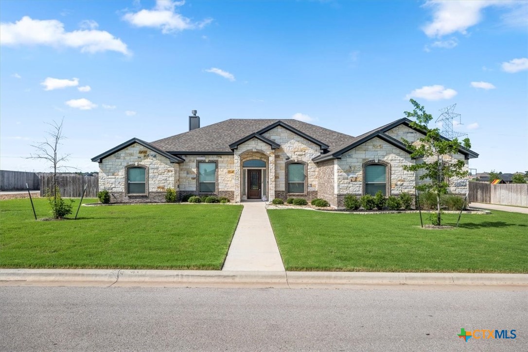 a front view of a house with a yard