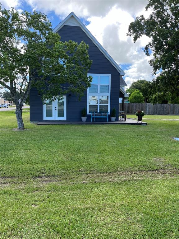 a view of a house with a yard and sitting area